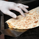 hands grilling a quesadilla